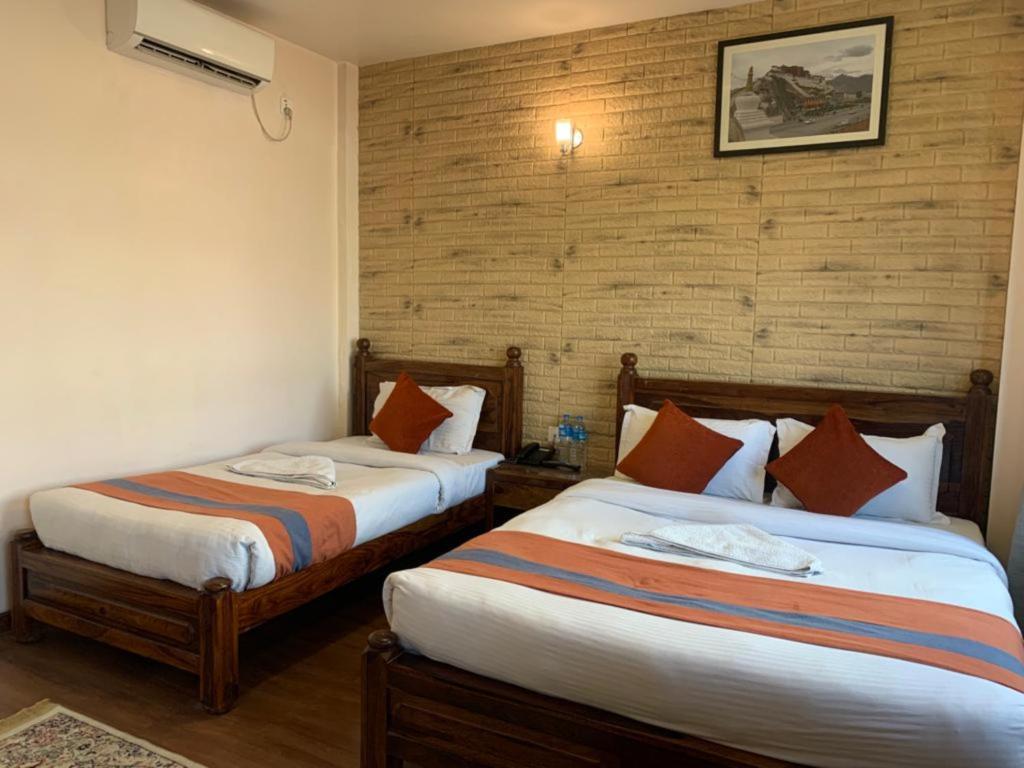 Postel nebo postele na pokoji v ubytování Hotel Ramanam