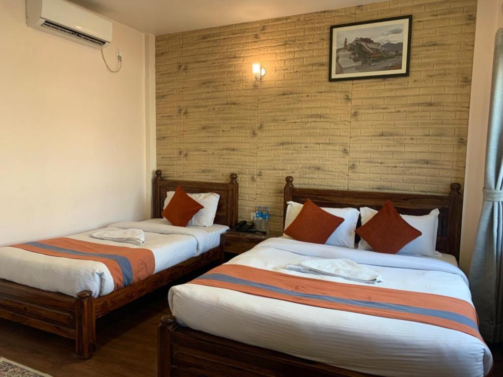 Postel nebo postele na pokoji v ubytování Hotel Ramanam