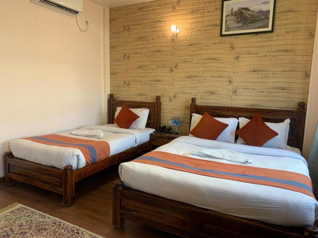 Postel nebo postele na pokoji v ubytování Hotel Ramanam