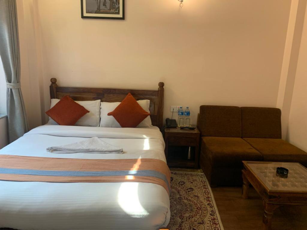 Postel nebo postele na pokoji v ubytování Hotel Ramanam