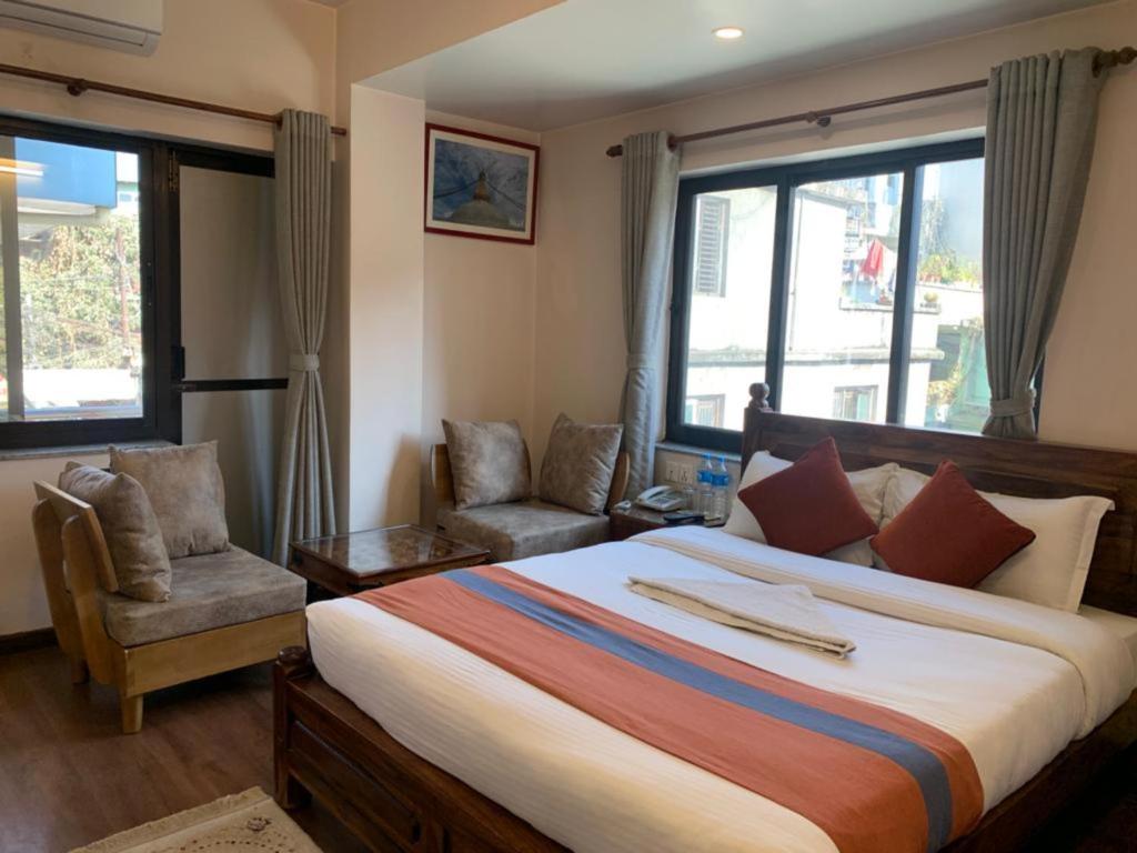 Postel nebo postele na pokoji v ubytování Hotel Ramanam