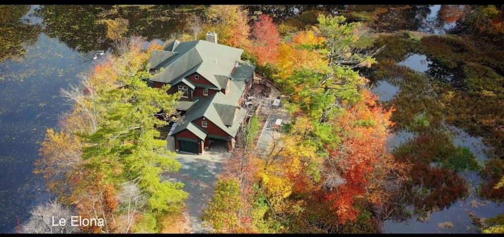 una vista aérea de una casa en medio de árboles en Le Elona, a private island getaway experience, en Peabody