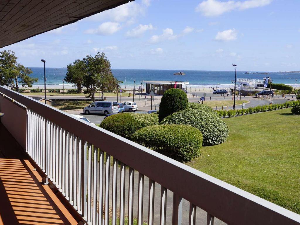 a balcony with a view of a beach and the ocean at Appartement 3* avec terrasse et parking, à 2 pas de la plage de Trestraou à Perros-Guirec - FR-1-368-244 in Perros-Guirec