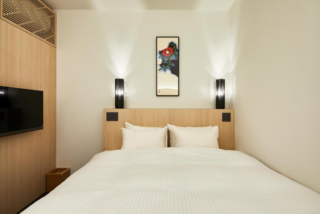 Postel nebo postele na pokoji v ubytování HOTEL KYOTOLOGY