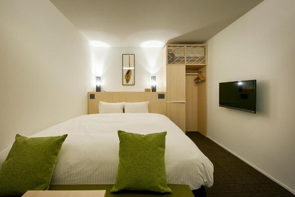 Postel nebo postele na pokoji v ubytování HOTEL KYOTOLOGY