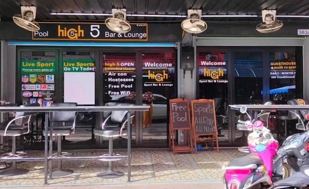 a restaurant with motorcycles parked in front of it at High5 Guesthouse in Pattaya Central