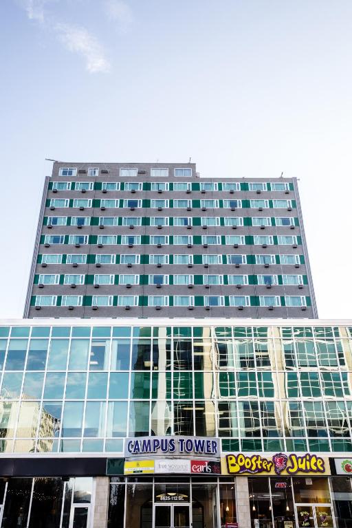 a tall building with a sign in front of it at Campus Tower Suite Hotel in Edmonton