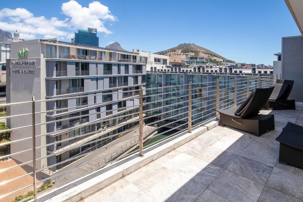 a balcony with a view of a building at Luxury 2 bed apart 515 Harbour Bridge, Dockrail Road, Foreshore, Cape Town, 8001, in Cape Town