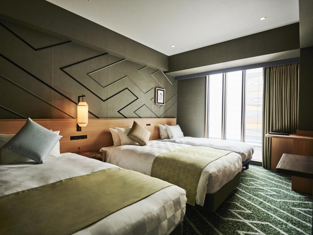 Postel nebo postele na pokoji v ubytování Asakusa View Hotel Annex Rokku