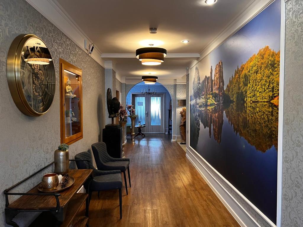 a hallway with a large painting on the wall at Gästehaus am Kurpark Hotel Garni in Horn-Bad Meinberg