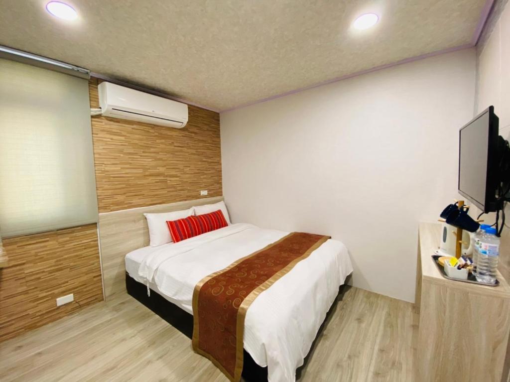 Postel nebo postele na pokoji v ubytování Beauty Garden Hotel - Jiaoxi