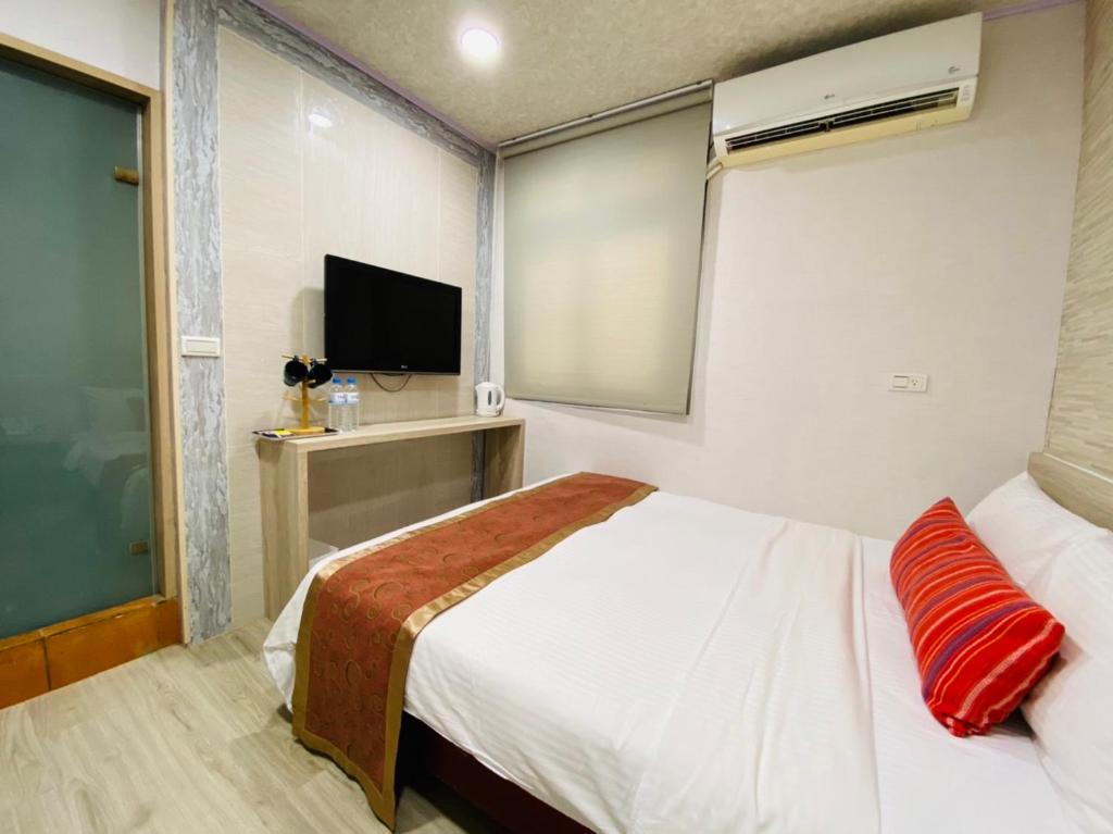 Postel nebo postele na pokoji v ubytování Beauty Garden Hotel - Jiaoxi