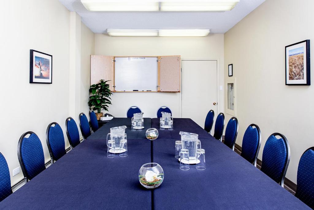 a conference room with a long table and chairs at Campus Tower Suite Hotel in Edmonton