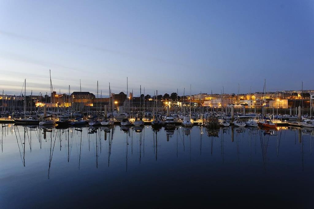 a group of boats docked in a harbor at night at Appartement 1 chambre proximité Port de commerce et Gare SNCF in Brest