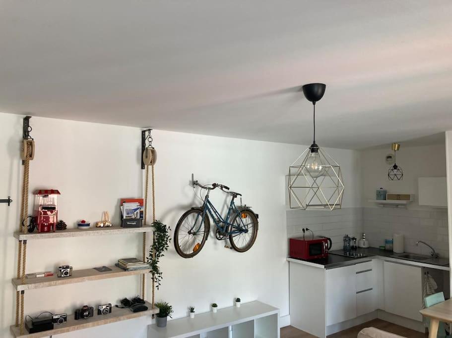 a kitchen with a bike hanging on the wall at Appartement 1 chambre proximité Port de commerce et Gare SNCF in Brest