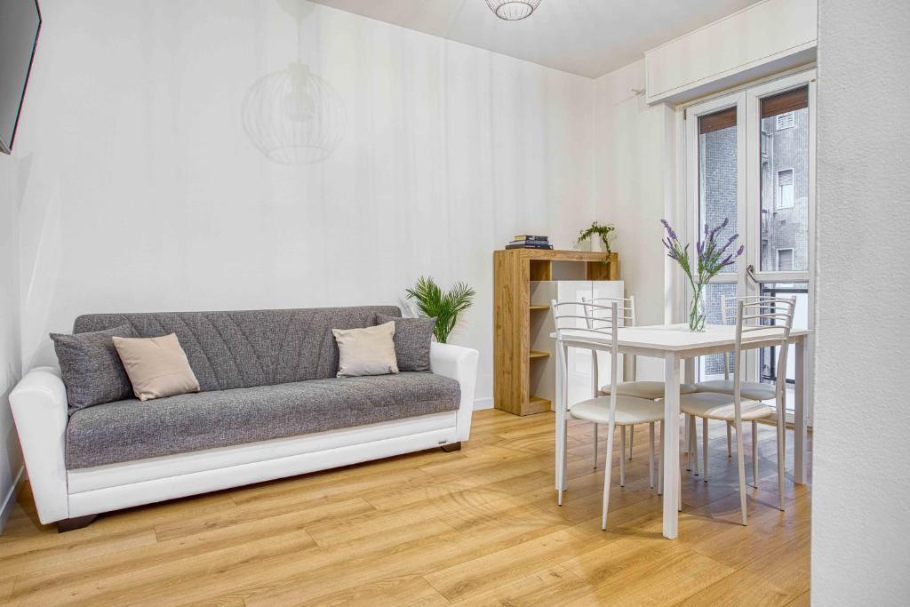 a living room with a couch and a table at ALTIDO Warm and Inviting flat with balcony in Milan