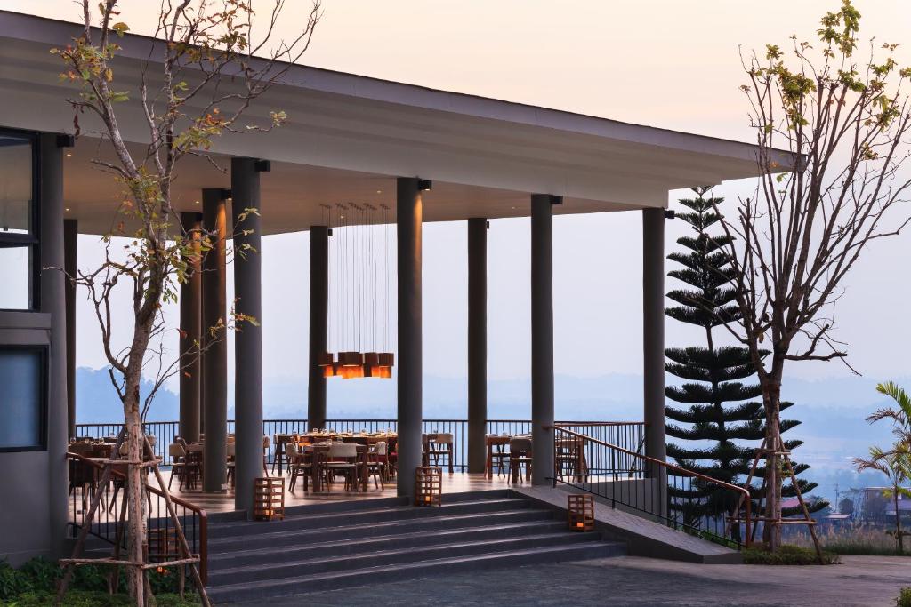 a pavilion with tables and chairs on a deck at Sirinati Khao Kho - Adults Only in Khao Kho