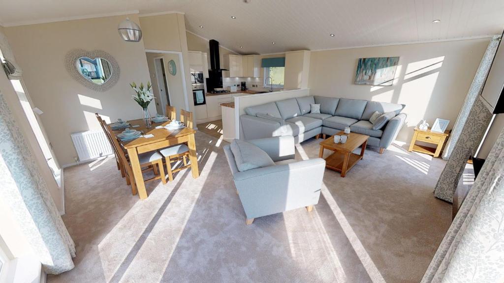 a living room with a couch and a table at Beech 26 Hot Tub in Garton