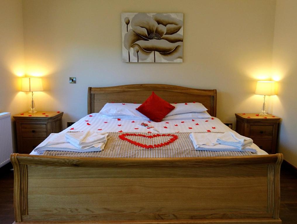 a bedroom with a bed with a red heart on it at Maple 14 Hot Tub in Garton