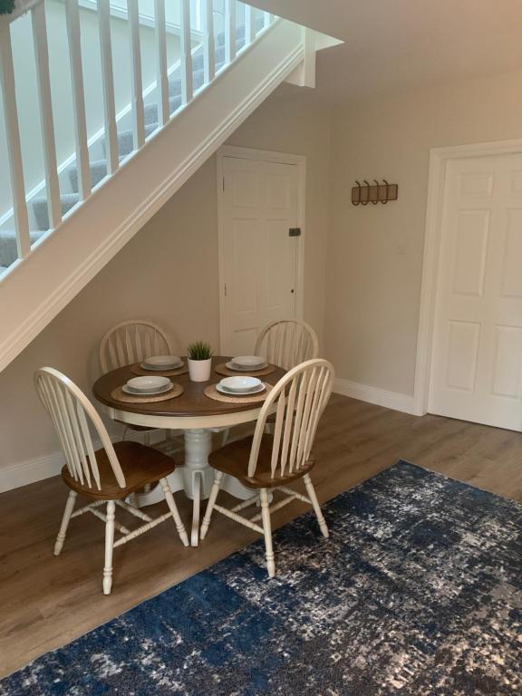 a dining room with a table and chairs at The Mews in Newbridge