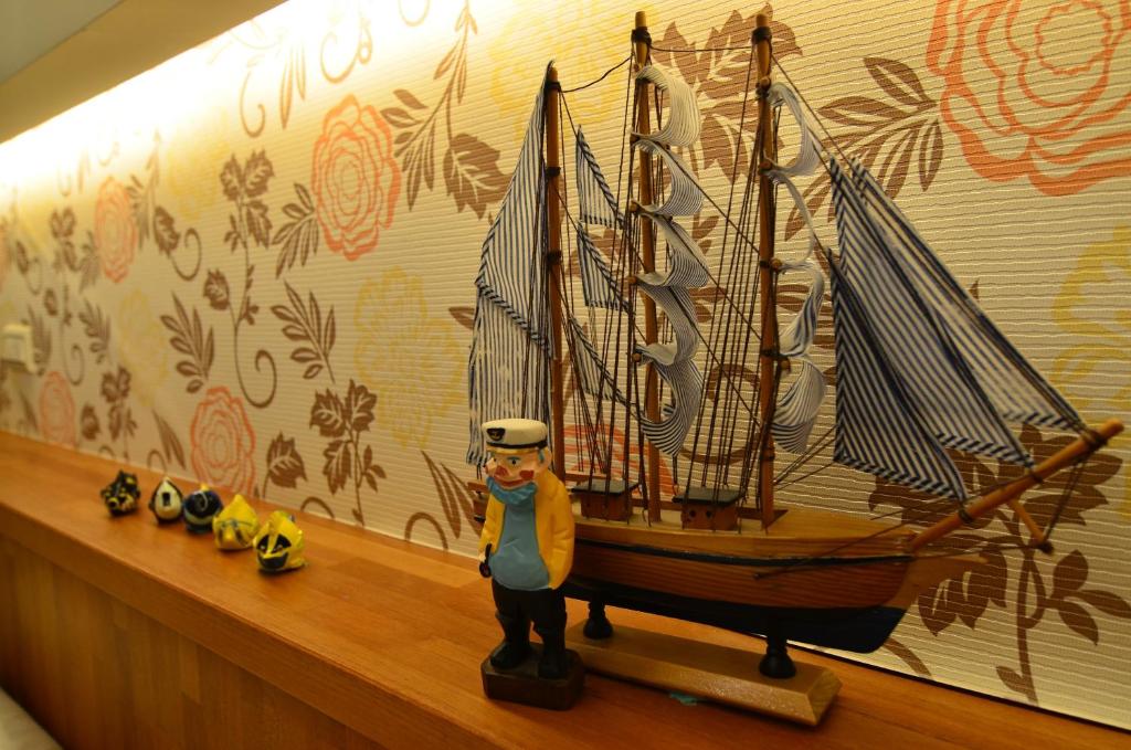 a toy boat on a shelf in a room at Fish Fun House in Hualien City