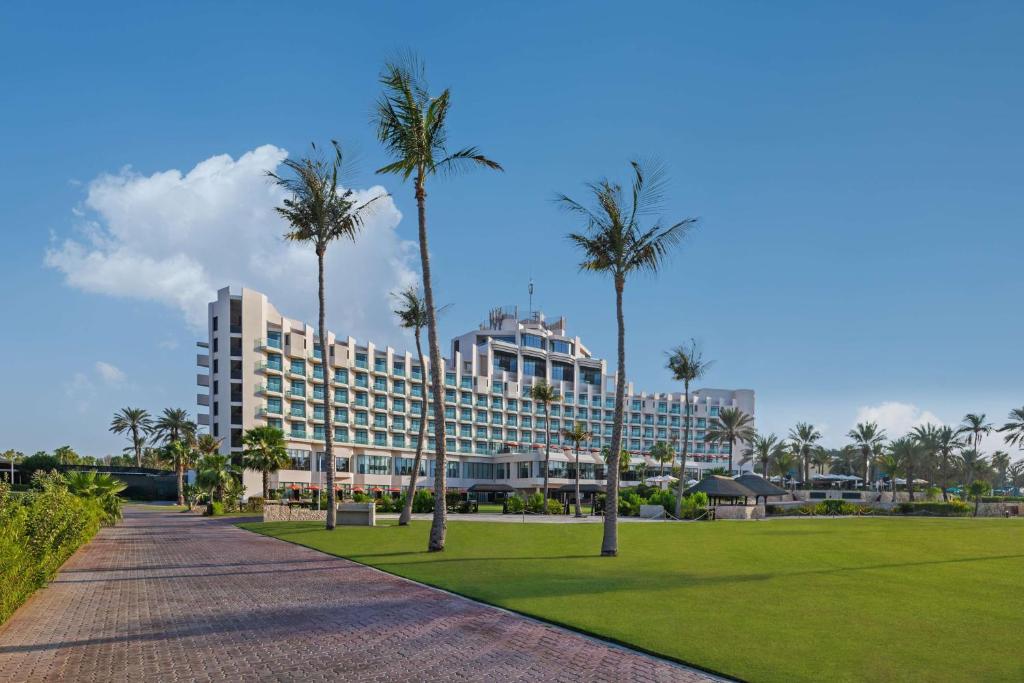 a resort with palm trees in front of a park at JA Beach Hotel (JA The Resort) in Dubai