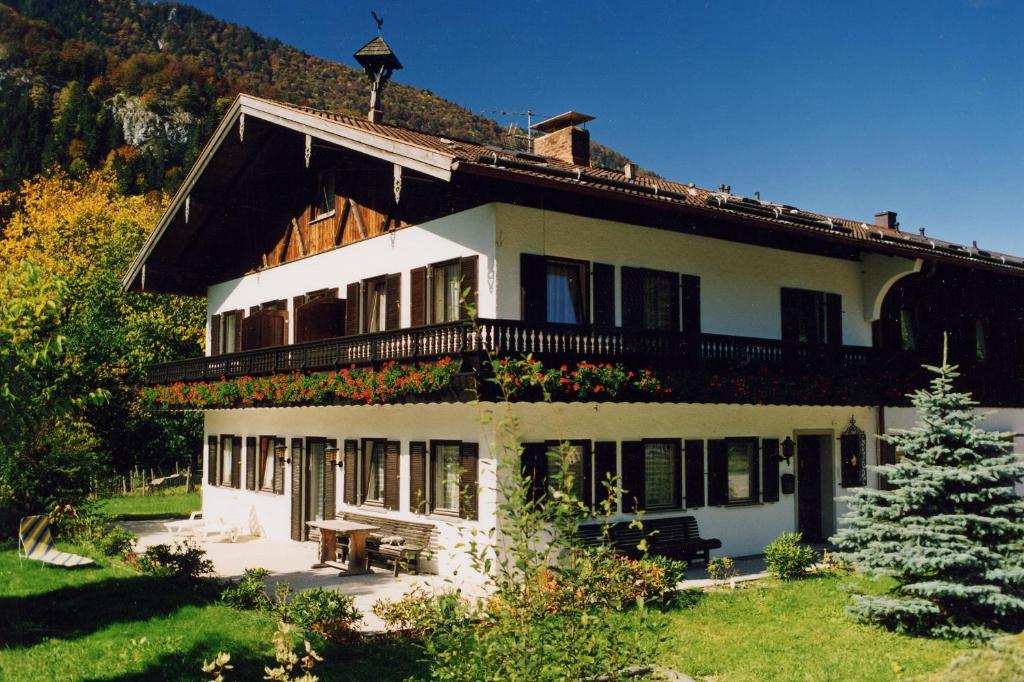 a large white house with a balcony on top of it at Pension Luger in Aschau im Chiemgau