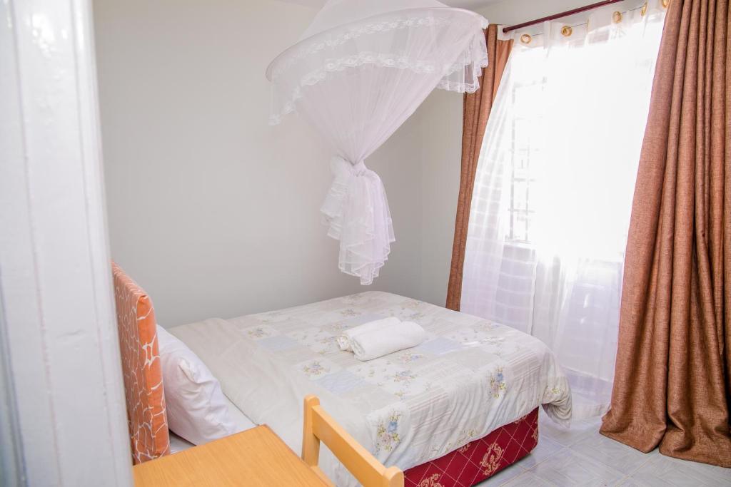 Postel nebo postele na pokoji v ubytování Nairobi Airport Apartments