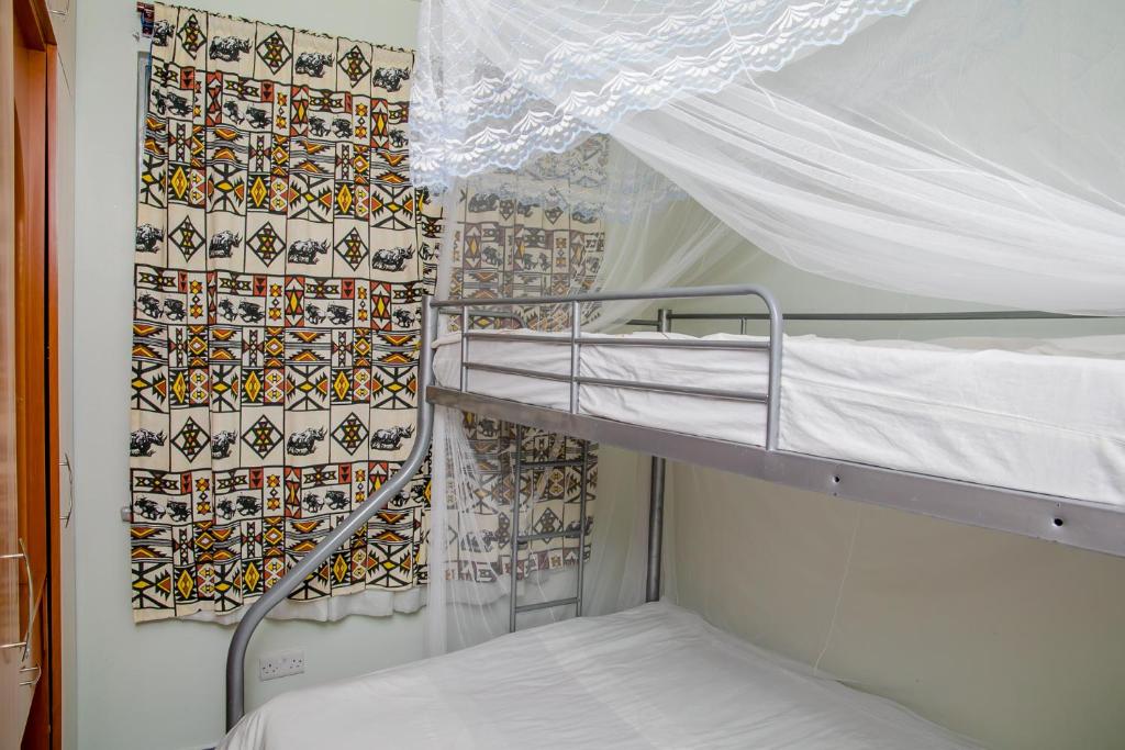 Postel nebo postele na pokoji v ubytování Nairobi Airport Apartments