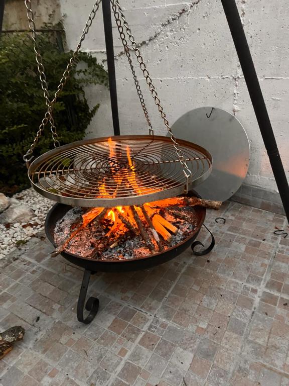 a grill with a fire in it on a patio at Casa serenaurora in Castel di Sangro