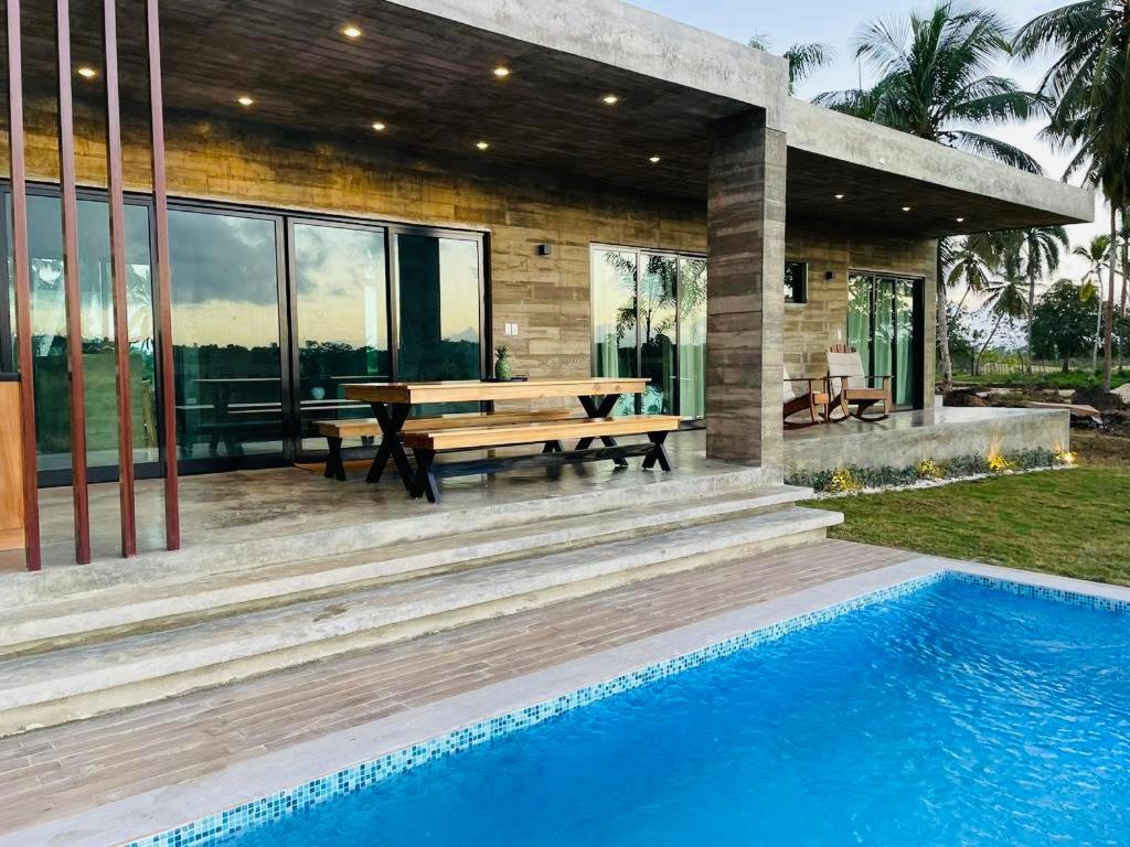 a house with a picnic table and a pool at Casa Carmela 