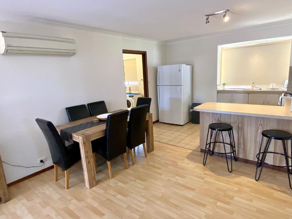 a kitchen and dining room with a table and chairs at Forrest Holiday Unit Bunbury in Glen Iris
