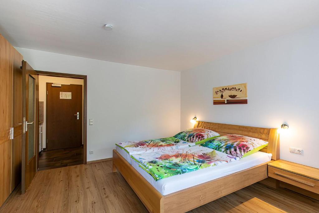 ein Schlafzimmer mit einem Bett in einem Zimmer in der Unterkunft Pension Berglehner in Bad Griesbach