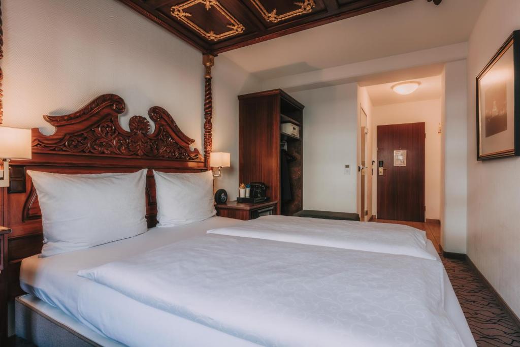 Postel nebo postele na pokoji v ubytování King's Hotel Center Superior