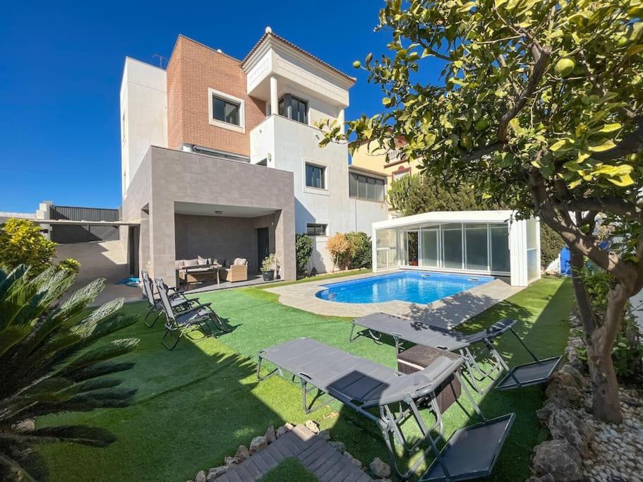 a house with a yard with a swimming pool at Villa Maritim in Torrox
