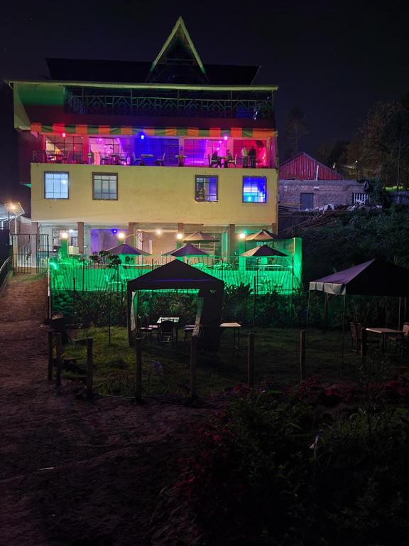 a building with green and purple lights in front of it at STERLEON HOTEL RIVERSIDE in Nairobi