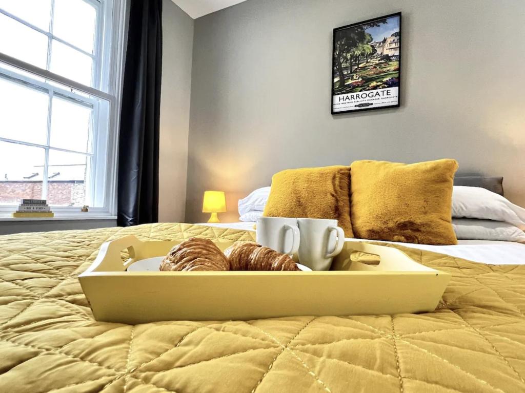 a tray of donuts sitting on top of a bed at Luxury Harrogate Flat with Free Parking in Harrogate
