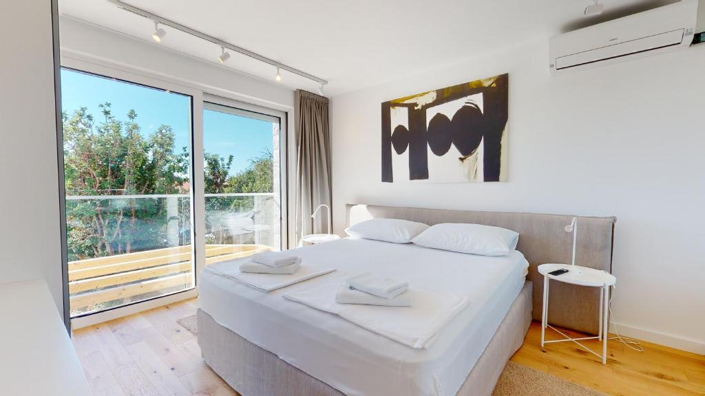 Postel nebo postele na pokoji v ubytování Villa Zoe Suites