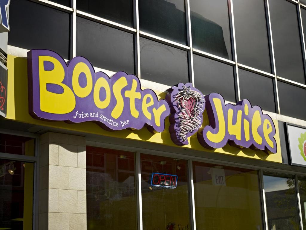 a building with a sign that reads booster juice at Campus Tower Suite Hotel in Edmonton