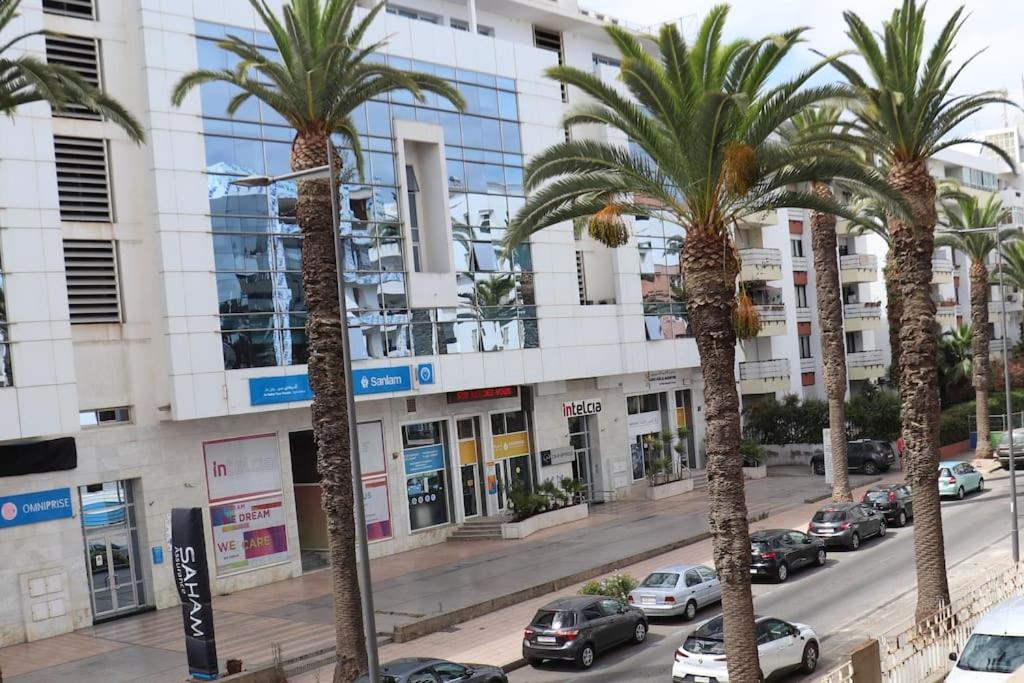 a row of palm trees in front of a building at Belle Vue in Rabat