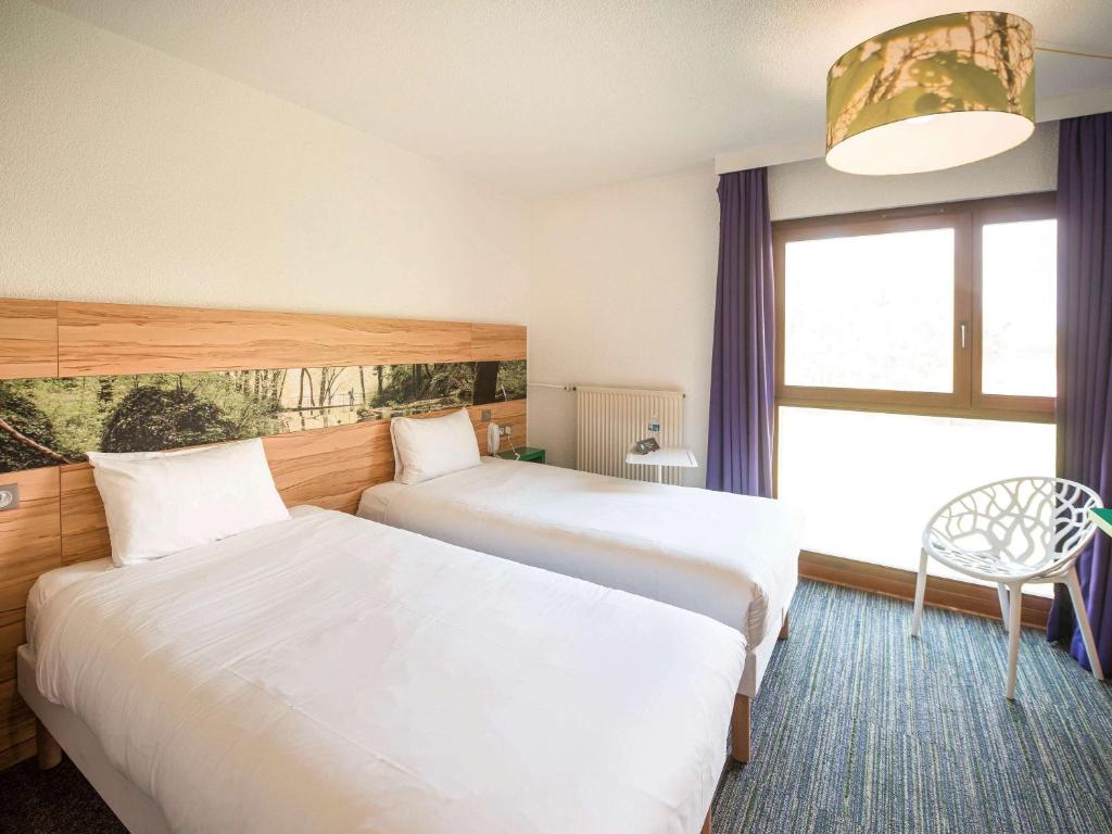 Postel nebo postele na pokoji v ubytování ibis Styles Sarrebourg
