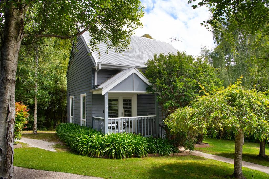 a gray house with a gambrel roof at Lake Orchard Villas in Daylesford