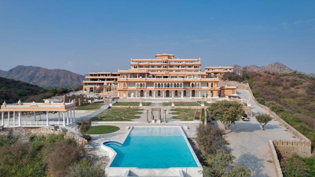 an aerial view of a large building with a swimming pool at Fateh Vilas by Fateh Collection in Udaipur