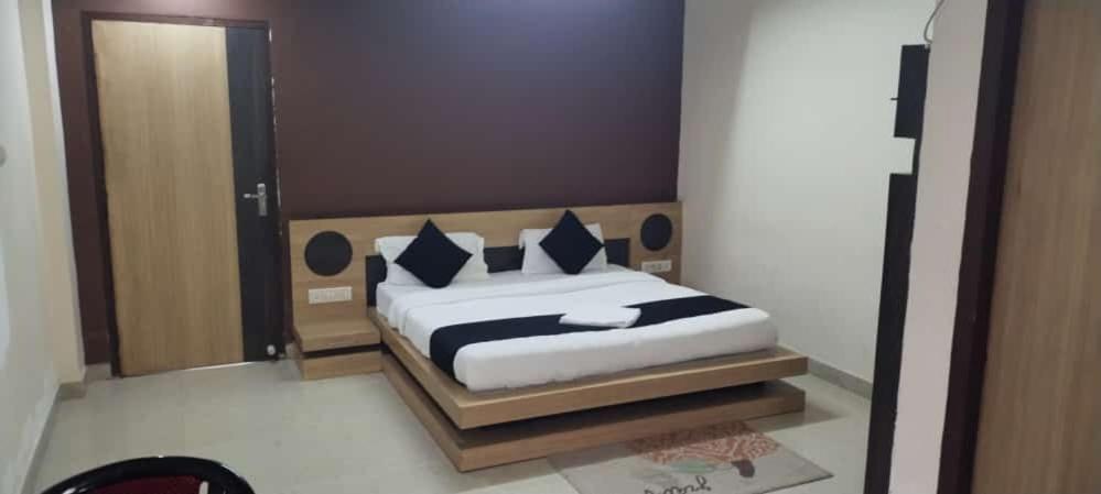 a bedroom with a bed and a large mirror at Hotel K J International in Pura Raghunāth