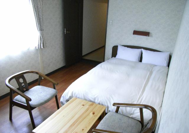 Postel nebo postele na pokoji v ubytování Sunplaza Rinkai