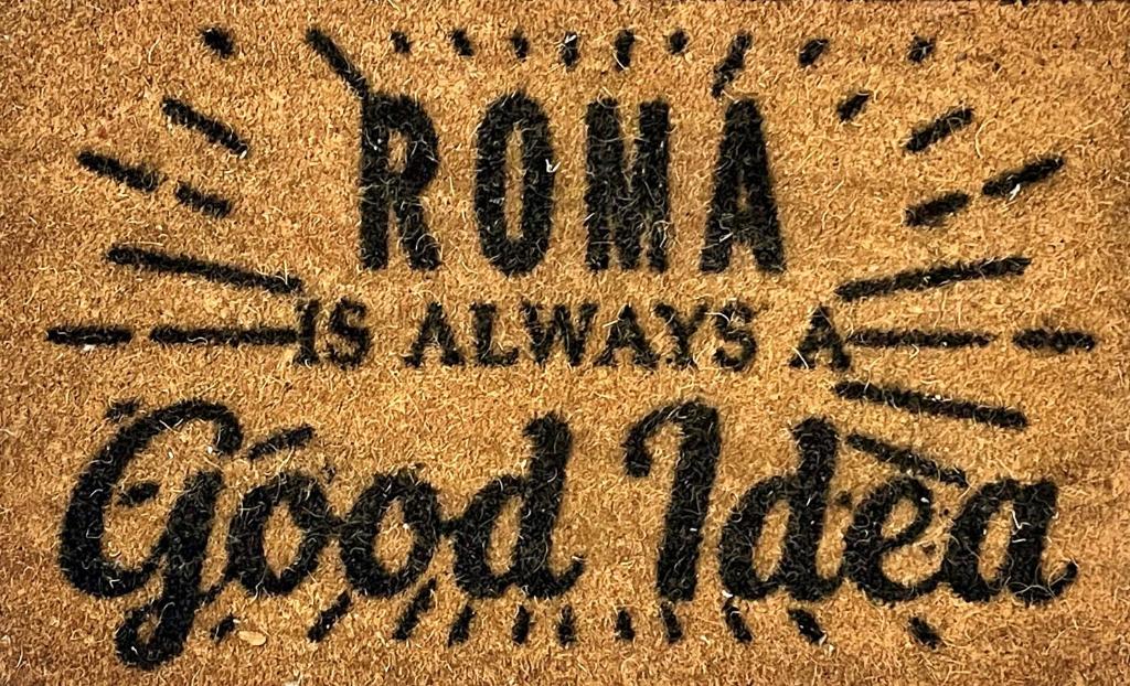 a sign in the sand that says rum is always a good idea at ROMA IS ALWAYS a GOOD IDEA in Rome