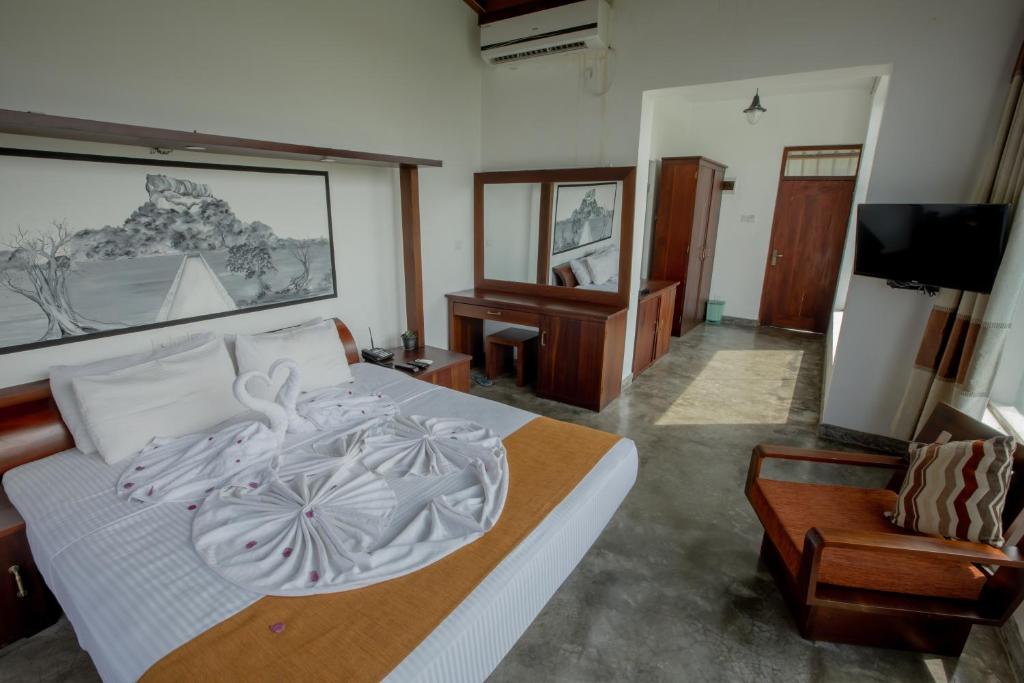 Postel nebo postele na pokoji v ubytování Sigiriya Wewa Addara Hotel - Hotel By The Lake