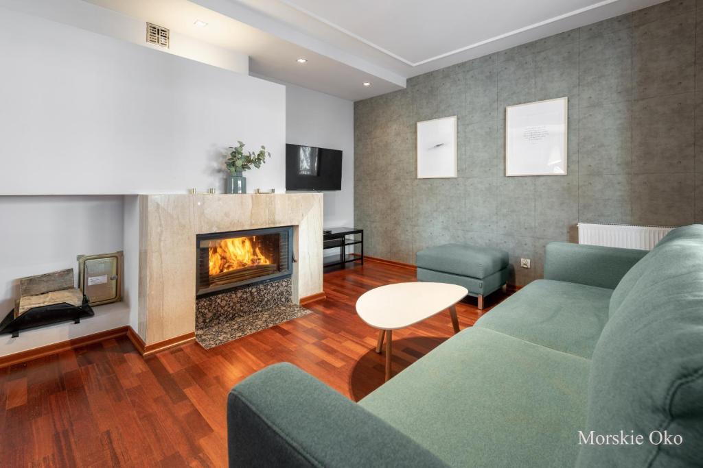 a living room with a couch and a fireplace at RentPlanet - Śpiący Rycerz in Zakopane
