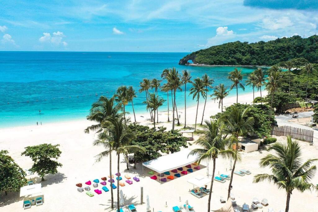 an aerial view of a beach with palm trees and the ocean at Boracay Condocation in Boracay