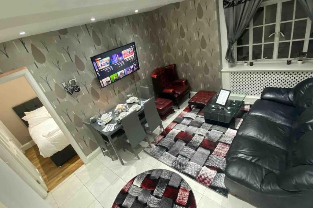 a living room with a couch and a television at Seymour - Marble Arch, Mayfair Apartments hosted by Maysa London in London